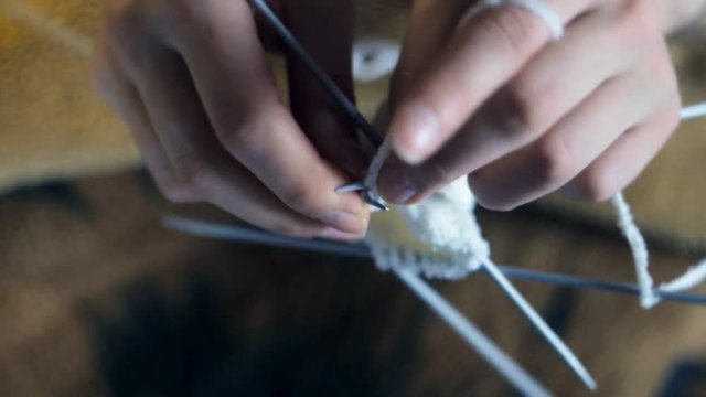 Woman knitting: hands close up shot. Needlework concept