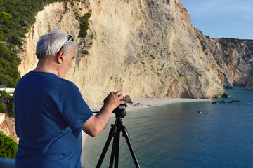 Man takes video of Katsiki Beach, Greece at sunset with his camera on tripod 
