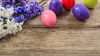 Colorful Easter eggs and copy space on wooden background