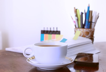 Office Table with Coffee Cup and Paper Stickers and Mobile Phone