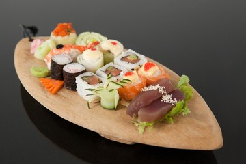 Assorted sushi set served in wooden boat plate