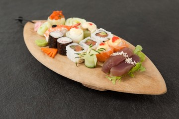 Assorted sushi set served in wooden boat plate