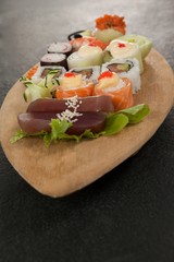 Assorted sushi set served in wooden boat plate