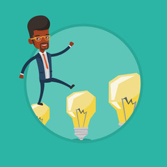 Businessman jumping on light bulbs.