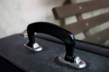 Suitcase Handle with Bench in Background