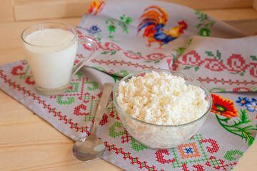 Cottage cheese in a glass plate and milk
