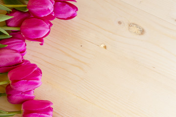 Bouquet of pink tulips on a wooden background

