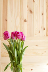 Bouquet of pink tulips on a wooden background

