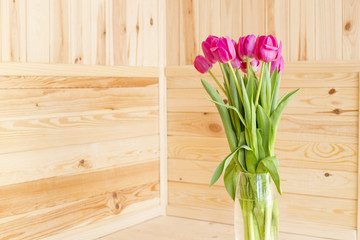 Bouquet of pink tulips on a wooden background
