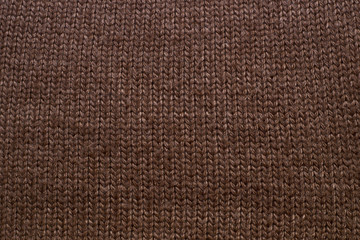 Fototapeta premium Knitted brown background. Fabric texture
