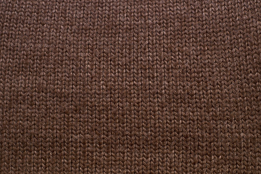 Knitted brown background. Fabric texture © urika