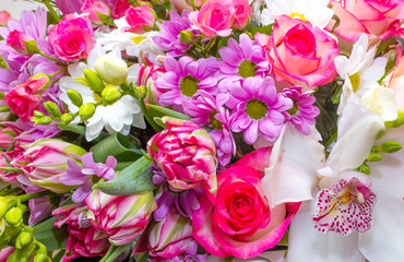 Bright background of flowers, roses, carnations and orchids.
