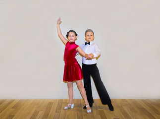 The young boy and girl posing at dance studio
