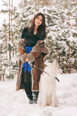 young beautiful girl walking in the husky dog in the forest
