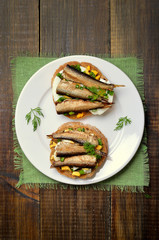 Appetizing sandwiches with sprats and egg