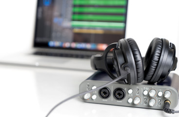 Obraz na płótnie Canvas Black Music Studio headphone lying on Computer Sound interface