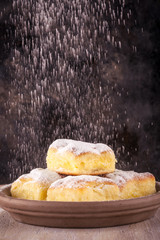 Homemade traditional cakes filled by curd with powder sugar