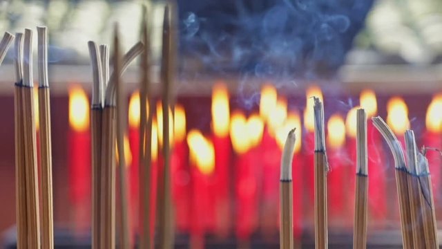 Smoke from incense sticks at chinese shrine slow motion