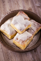 Top view on Homemade traditional cakes filled by curd on wooden board