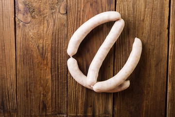 Homemade sausages on a wooden background. Sausages. White sausages