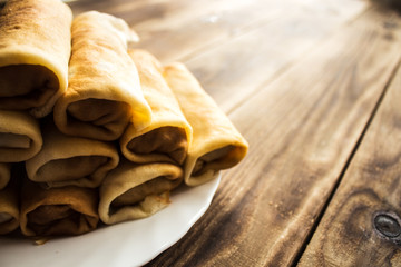 stuffed crepe stacked on white plate