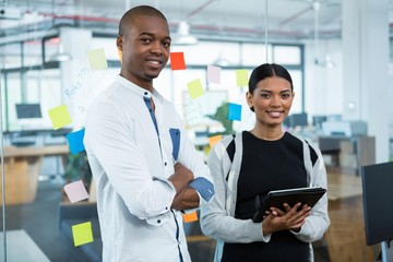 Fototapeta premium Portrait of business colleagues using digital tablet in office
