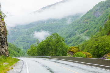 Foggy landscape with road in norwegian mountains