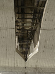 arched concrete structure under a bridge