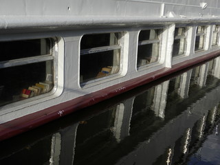 Fototapeta premium boat windows reflected in a water level