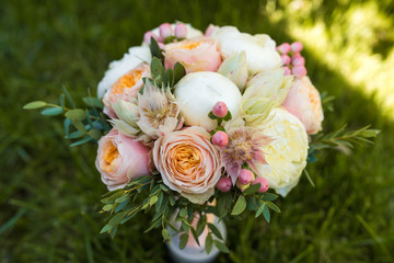 Wedding bridal bouquet of flowers and greenery is on a white table