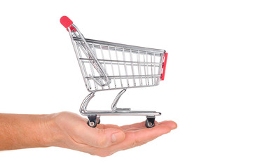 Hand holds shopping cart isolated on white background