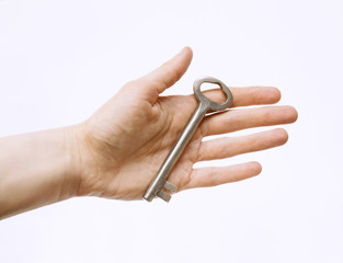 Vintage large key in human hand on white background