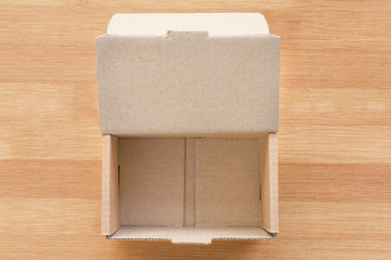 Open cardboard box on wooden background