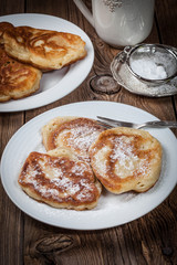 Naklejka na ściany i meble Polish pancakes with powdered sugar.