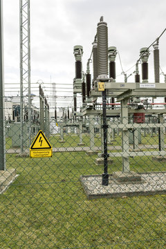 Fence of a transformer station with a yellow sign danger to life