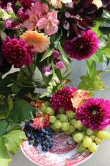 Still life flower decoration with grapes in autumn