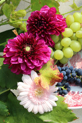 Still life flower decoration with grapes in autumn