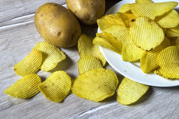 potatoes and potato products, fried potato slices, potato slices fried serrated, fried potato flakes in a furnace,
