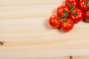 Fresh red tomatoes on the wood table, isolated