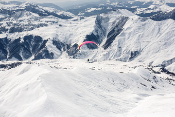Naklejka na ściany i meble Winter paragliding in Gudauri mountains