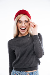 Happy excited woman in hat and glasses looking at camera