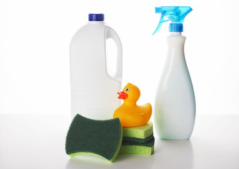The bottles with cleaning chemistry and green sponges with the duck on the top.