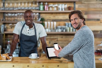 Man using mobile phone at counter 