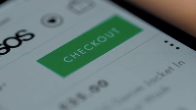 Close-up Of Person Holding Credit Card With Mobile Phone Showing Shopping Cart Symbol, checkout