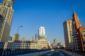Fototapeta na wymiar SHANGHAI, CHINA: Some tall modern buildings making up the horizon, walking on the streets of Shanghai