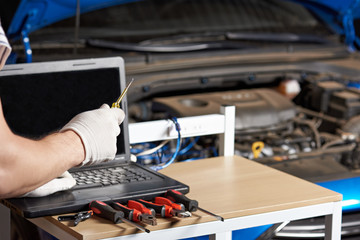 Closeup of car mechanic hands