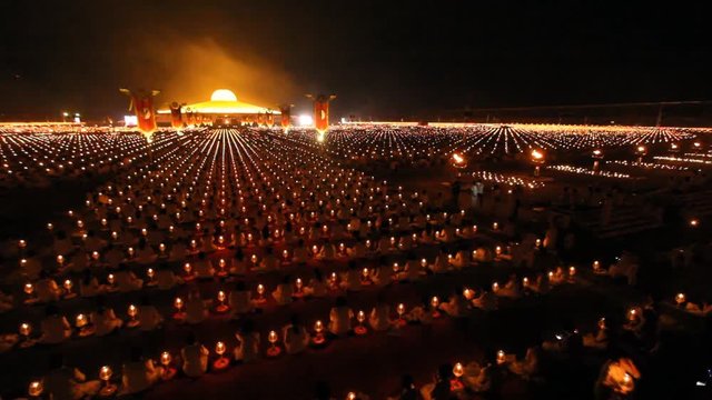 Thousands of people take part in evening prayers to mark Makha Bucha Day at Wat Dhammakaya temple in Thailand.