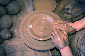 Craftsman artist making craft, pottery, sculptor from fresh wet clay on pottery wheel