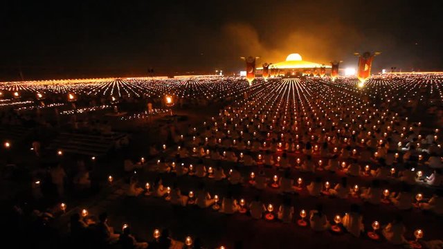 Thousands of people take part in evening prayers to mark Makha Bucha Day at Wat Dhammakaya temple in Thailand.