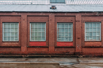 Fototapeta na wymiar Vintage building brick wall, large windows background, old architecture street. 